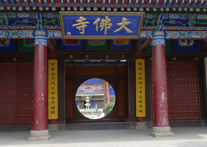 Day 6 The Dafo (Great Buddha) Temple, the home of the largest indoor reclining Buddha in all of China. This huge Buddha measuring 35 meters (115 feet) long was constructed of of clay over a wooden frame sometime around 1100 A.D. It remains largely unaltered since the days of the Western Xia Dynasty (1038 – 1227 A.D.) and it is amazing that it has survived intact for more than 900 years.
Day 6 The Dafo (Great Buddha) Temple, the home of the largest indoor reclining Buddha in all of China. This huge Buddha measuring 35 meters (115 feet) long was constructed of of clay over a wooden frame sometime around 1100 A.D. It remains largely unaltered since the days of the Western Xia Dynasty (1038 – 1227 A.D.) and it is amazing that it has survived intact for more than 900 years.